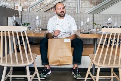 Matt Baker, chef and owner of Gravitas, poses for a portrait inside the restaurant, Tuesday, Feb. 14, 2023, in Washington. Gravitas has a subscription service offering a monthly meal for two. (AP Photo/Jacquelyn Martin)