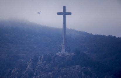 One of the helicopters, that will transfer Franco’s remains, flies above the Valley of the Fallen.