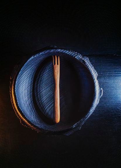 A charred bowl with fork made from walnut wood. 