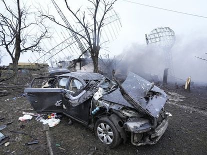 A car that was left damaged after an airstrike at the military airport in Mariupol, Ukraine.