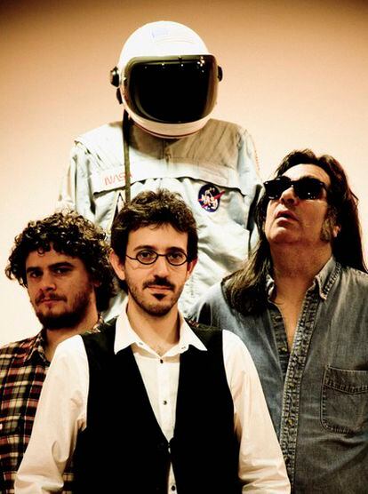 Rafa, Jorge and Danny of the Stormy Mondays, pose with Neil Armstrong's space suit.