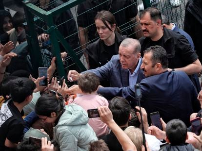 Turkey's President Recep Tayyip Erdogan with supporters at a polling station, in Istanbul, Turkey, Sunday, May 14, 2023.