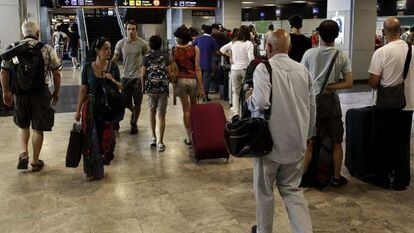 Passengers at Adolfo Suárez Madrid-Barajas International Airport.