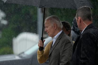 President Joe Biden walks with Annie Tomasini in the rain from St. Edmond Roman Catholic Church after attending Mass in Rehoboth Beach, Del. Saturday, May 13, 2023.