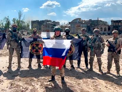 Yevgeny Prigozhin, head of the Wagner military company, holds a Russian flag in front of his soldiers in Bakhmut, Ukraine, May 20, 2023.