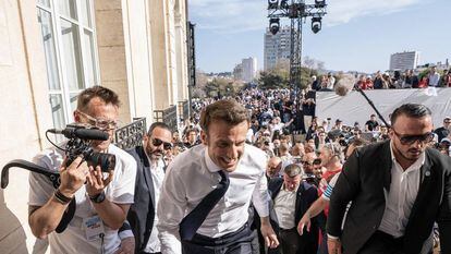 Macron climbing the steps to hold a rally with his supporters on April 16 in Marseille.