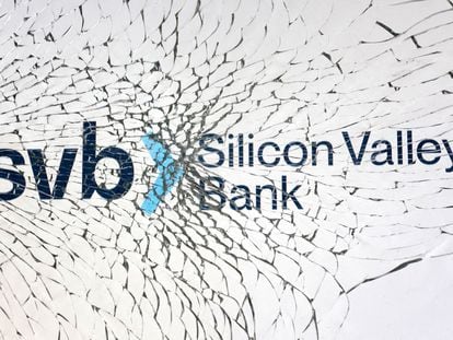 SVB (Silicon Valley Bank) logo is seen through broken glass.