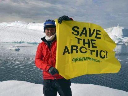 Alejandro the activist: Sanz holds aloft a Greenpeace flag during his eight-day Arctic trip.