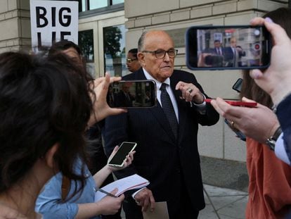 Rudy Giuliani answers questions from the press outside a New York courtroom in May.