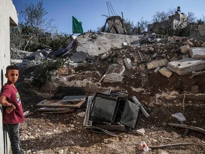 A Hamas flag flies last Tuesday over the remains of the house of Hamas deputy leader Saleh al-Aruri, which was demolished by the Israeli army.