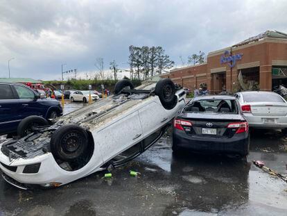 A car is upturned in a Kroger parking lot after severe storm swept through Little Rock, Ark., Friday, March 31, 2023.