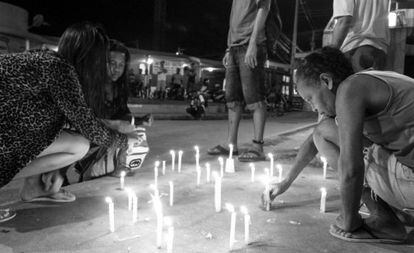 Residents of a building in Alemão, in Rio de Janeiro, light candles after the violent death of a child in April.