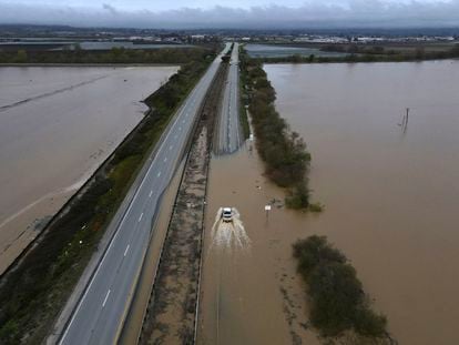 A CalTrans vehicle drives north through floodwaters that closed state Highway 1 at the Santa Cruz County line, in California, on March 12, 2023.