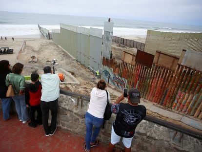 People observe a construction crew working in the replacement of the corroded primary border wall between Mexico and U.S., as seen from Playas de Tijuana, Mexico October 16, 2023.