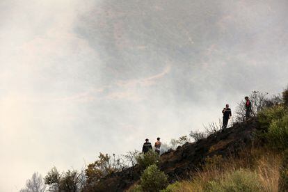 Firefighters after they put out the fire in the village of Zberber, Bouira province in the mountainous Kabyle region, Algeria, 24 July 2023.