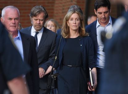 Felicity Huffman leaves the Boston courthouse with her husband, William H. Macy, after being sentenced to 14 days in jail for the college admissions fraud scheme in September 2019.