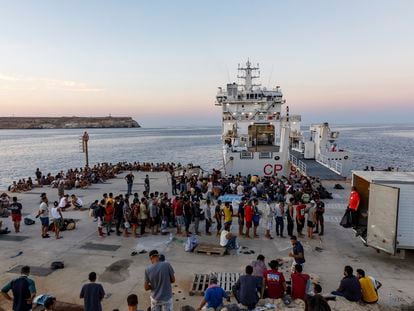 Migrants wait to board an Italian Coast Guard ship in the Sicilian Island of Lampedusa, Italy, in August 2022.