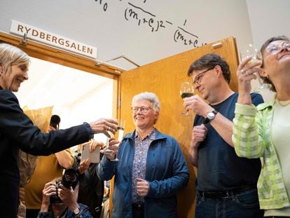 Physicist Anne L'Huillier (center) celebrates winning the Nobel Prize with colleagues at Lund University in Sweden.