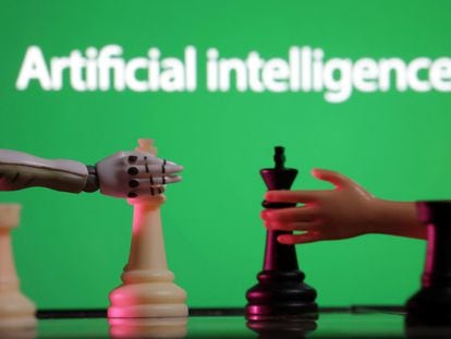 Words reading "Artificial intelligence", miniature of robot and toy hand are pictured in this illustration taken December 14, 2023.