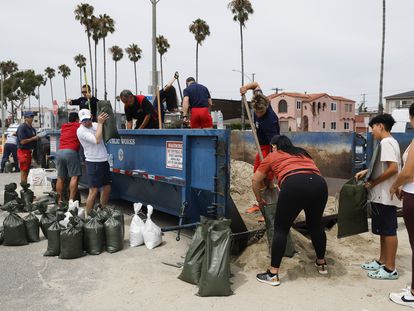 Long Beach residents fill sandbags to prepare for possible flooding caused by the storm.
