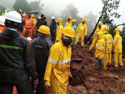 National Disaster Response Force (NDRF) personnel along with others perform a rescue operation after a landslide in Irshalwadi village in Raigad district, Maharashtra, India, 20 July 2023.