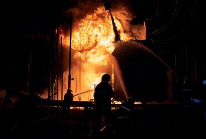 Ukrainian firefighters try to put out a fire at a Kharkiv power plant caused by Russian missiles on September 11, 2022.