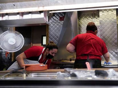 Women work in a restaurant kitchen in Chicago, Thursday, March 23, 2023.
