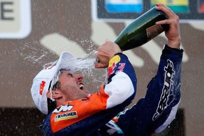 Marc Coma celebrates on the podium after winning a fourth Dakar Rally. 