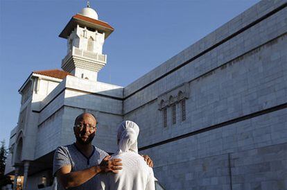 Mohamed and his daughter who has been allowed to wear her headscarf to school, posing in front of Madrid's M-30 mosque.