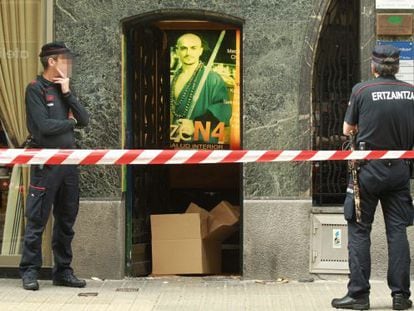 Ertzaintza police officers keep watch over the martial arts premises in Bilbao where human remains have been found. 