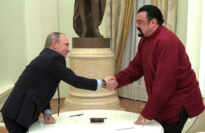 Russian President Vladimir Putin shakes hands with U.S. actor Steven Seagal in the Kremlin in Moscow, during a ceremony to award a Russian passport, Nov. 25, 2016.