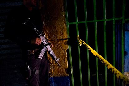 A police officer stands guard outside a crime scene in San Salvador.