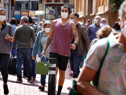 People wearing face masks on the streets of Terrassa in Barcelona on Monday.