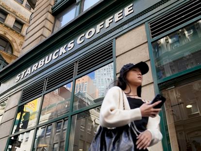 Pedestrians pass a Starbucks in the Financial District of Lower Manhattan, Tuesday, June 13, 2023, in New York.