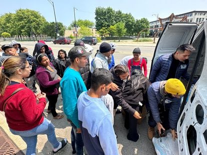 Migrants are given supplies outside the District 12 station of the Chicago Police Department in Chicago, Illinois, U.S. May 17, 2023.