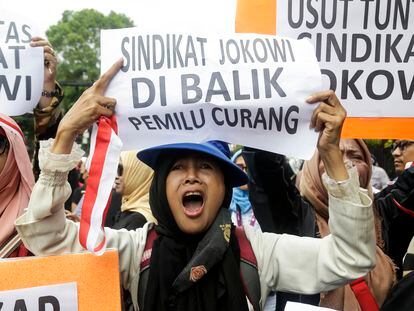 A supporter of Indonesian Presidential candidate Anis Baswedan and running mate Muhaimin Iskandar shouts slogans and holds a poster reading 'President Joko Widodo's syndicate is behind the fraudulent election' during a protest in front of the Election Commission Office in Jakarta, Indonesia, 16 February 2024.