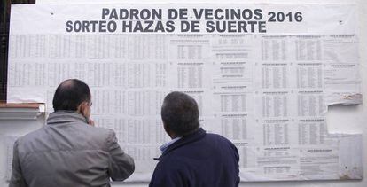 Locals check their names on the 'lucky lands' land raffle in Vejer de la Frontera.