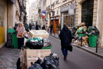 A man walks past uncollected garbages in Paris, Wednesday, March 15, 2023 as sanitation workers are on strike. Opponents of French President Emmanuel Macron's pension plan are staging a new round of strikes and protests as a joint committee of senators and lower-house lawmakers examines the contested bill. 
