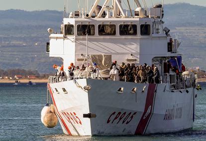 The Italian coast guard ship Peluso enters the Sicilian harbor of Catania, Italy, on April 17, 2023, with some 300 migrants saved from the sea.