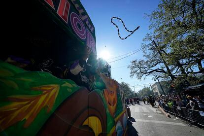 Members of the Krewe of Zulu parade throw beads from a float during Mardi Gras on Tuesday, March 1, 2022, in New Orleans.
