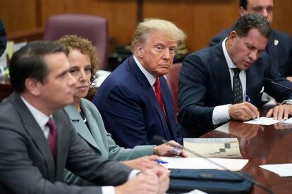 Former President Donald Trump sits at the defense table with his legal team in a Manhattan court, Tuesday, April 4, 2023