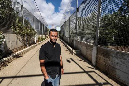 Saadat Ghryib in the corridor leading to his home in the Palestinian village of Beit Ijza. The village has been swallowed up by the Israeli settlement of Givon Hahadasha, in the occupied West Bank.