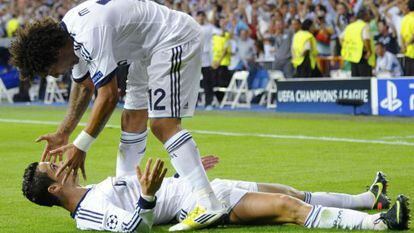 Real Madrid&#039; s Ronaldo celebrates with team mate Marcelo (top) after scoring a goal against Manchester City.
