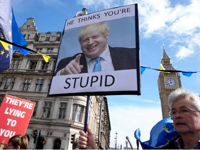 Protestors show placards as they demonstrate near Parliament in London, onMarch 22, 2023.