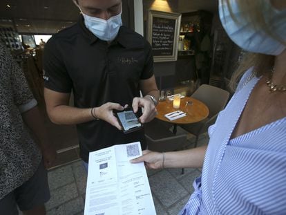 A staff member checks a Covid passport in Corsica.