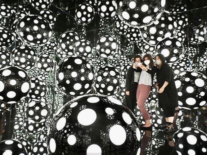 Young women take a selfie at a Yayoi Kusama installation at the M+ Museum in Hong Kong.
