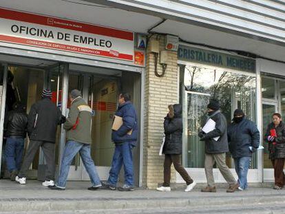 People line up outside an unemployment office in Madrid.