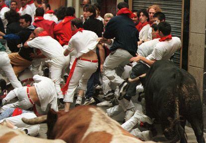 A runner is gored during the seventh running of the bulls in the year 2000.