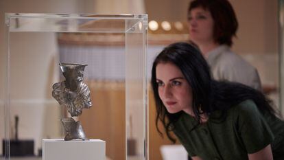 A visitor observes a vase in the exhibition ‘Luxury and power: Persia to Greece’ in the British Museum.