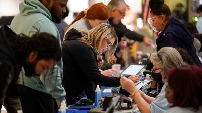 People check in to cast their votes at a polling station in a mall on November 8, 2022, in Las Vegas.